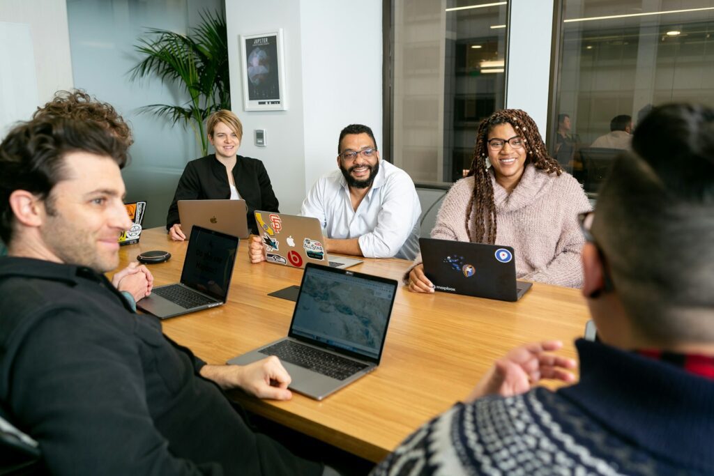 Diverse leadership team collaborating around a table in a working session