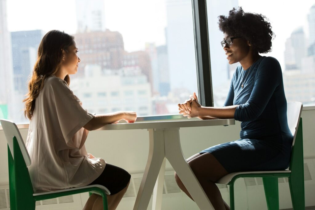 Two colleagues in a candid one-on-one conversation
